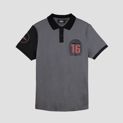 A short-sleeved grey polo shirt with a collar, featuring a large embroidered logo on the front and a subtle graphic on the back. The shirt is made from 100% cotton.