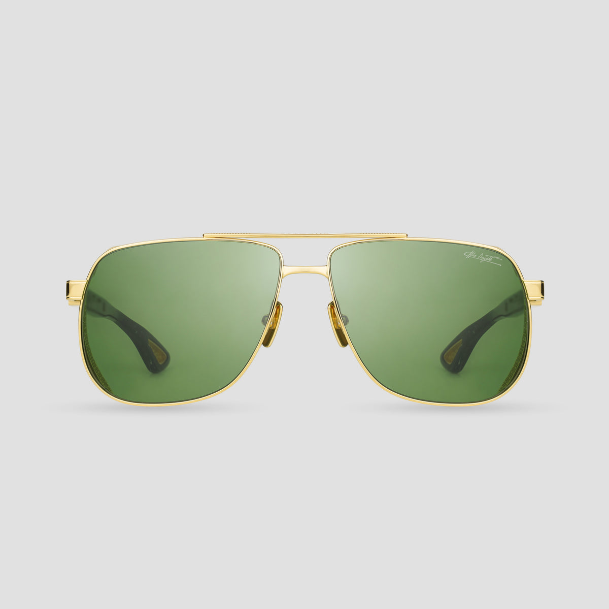 Gold-framed sunglasses with green lenses on a light gray background